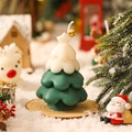 Miniature green Christmas tree scented candle with white snow top and golden bell decoration - White + Green
