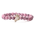 Close-up of pink textured beaded bracelet with a white dolphin charm on white background - Pink Turquoise