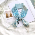 Close-up of blue floral silk scarf featuring a printed letter K on a clean white background - Sketch Spring Letter K