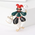 Detailed view of enamel clown brooch with colorful crystals and a large white faux pearl - Green