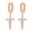 Macro shot of rose gold dagger drop earrings with white cubic zirconia pavé setting - Rose Gold Dagger