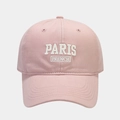 Close-up of pink cotton baseball cap featuring white embroidered Paris French lettering - Pink