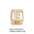 Macro shot of 8mm gold letter E bead with micro-pave cubic zirconia for DIY jewelry - Letter E