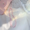 Macro shot of colorful acrylic heart beads on a pink iridescent phone lanyard strap - Pink Heart