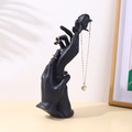 Matte black resin hand-shaped jewelry stand with rose detail for rings and necklaces - Black