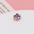 Macro shot of a purple square zircon pendant with a golden claw setting for DIY jewelry - Violet