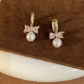Elegant gold-tone bow earrings with pink stones and white pearls on velvet base - Bowknot Pearl Hoop Earrings Gold