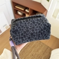 Furry leopard print makeup bag with woven handle in soft plush faux fur material - Handheld Plush Black Leopard