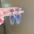 Macro detail of elegant silver needle drop earrings with vibrant blue pear-shaped stones. - Dark Blue Stone Multicolor Rhinestone
