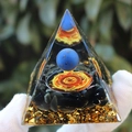 Crystal pyramid with blue sphere, glowing rune, and black stone base held in hand - Lapis Lazuli Ball Ego / Small