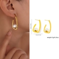 Golden U-shaped stainless steel earrings with white faux pearl in modern geometric style - Zjge0488