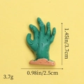 Macro view of green resin zombie hand charm with size dimensions 3.7cm by 2.5cm - Dark Green Ghost Claw