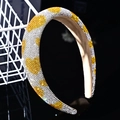 Macro shot of sparkling yellow and silver rhinestones forming hearts on a padded headband - Yellow & White Rhinestone Heart
