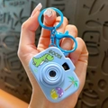 Cute light blue cartoon dinosaur projector camera keychain and bag accessory charm - Blue