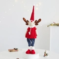 Close-up of a Christmas reindeer plush with red knit hat and blue pants on white stage - Standing Reindeer Female in Red Sweater