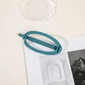 Detailed view of large matte teal hair claw clip on a stylish lifestyle background - Oval - Peacock Blue