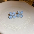 Asymmetric light blue clover stud earrings with crystals on a ceramic display - Clover Crushed Stone Texture Studs (3#)