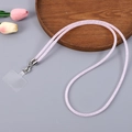 Detail of pink sparkling crossbody phone strap with metal clasps and transparent patch - Light Pink