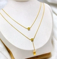 Double-layered golden necklace with square cube pendants on white model stand - Gold