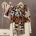 Detail of leopard print scarf with soft fringe edges over a classic beige autumn coat - 180*70cm / Dark Camel White