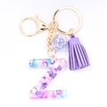 Detail of Letter Z resin keychain with purple stones, star sequins, and suede tassel - Letter Z