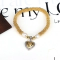 Detail view of golden beaded bracelet with white pearls and a heart zircon pendant - Elegant Rhinestone Heart Pendant (Style 4)