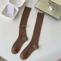 Brown ribbed knee-high socks in vintage style displayed with aesthetic props - One Size / Dark Coffee