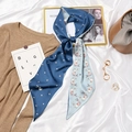 Polka dot and rabbit pattern silk scarf tied on a bag in a stylish setting - #388 Round Dot Rabbit Light Deep Blue