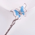 Macro detail of a silver hair stick featuring a blue enamel butterfly with rhinestones - Silver Blue White Enamel Butterfly Rhinestone (FZ030)