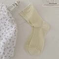 Milk white cotton crew socks with vertical ribbed texture on a minimalist desk - One Size / Light Green