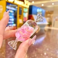 Close-up of a pink donut liquid sand acrylic keychain with candy shell and cute resin models - Round Candy / Luminous Donut Round Candy