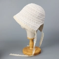 Close-up view of intricate hollow-out crochet texture on a white lace sun hat - M (56-58cm) / Milky White