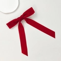 Detailed texture of a vintage burgundy velvet bow hair clip with elegant long streamers - Red