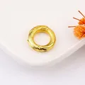 Golden ring pendant with intricate relief textures on a white ceramic plate - 6# Sand Gold Universe Loop