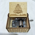 Hand-cranked wooden music box featuring festive laser-engraved Christmas greetings - Christmas 34/Wood Color/Holly Jolly Engraving