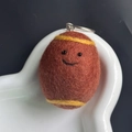 Handmade brown wool felt oval keychain with cute yellow stripes and a smiling face - Rugby Ball