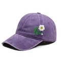 Detail view of purple washed cotton baseball cap featuring delicate white daisy embroidery - One Size / Purple