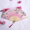 Elegant pink bamboo folding fan with floral patterns and matching decorative tassel charm - Pink Floral Pattern Style (Women's Fan-61)