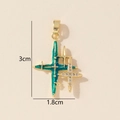 Detail shot of a star cross pendant with green enamel and zircons, dimensions 3cm by 1.8cm - Gold Cross Star