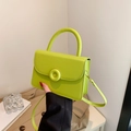 Neon green glossy crossbody bag with gold circular lock and long shoulder strap - Green