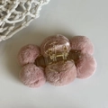 Detail of pink faux fur pom-poms on a transparent claw clip for women's hair styling - Light Pink