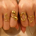 Set of four textured gold stainless steel rings including heart and organic shapes - 4Pcs Stainless Steel Gold Rings Set (06)