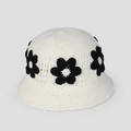 Close-up of handmade crochet bucket hat featuring intricate knit textures and daisy flowers - White