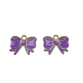 Detailed close-up of purple alloy bow pendants with gold edges for DIY jewelry making - Purple
