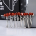 Detail of handmade silver hair comb with red crystal stone beads in a macro shot - Redstone + 20-Tooth Silver Comb