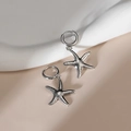 Pair of minimalist silver starfish pendant hoop earrings on soft wave texture - Steel Color - Starfish Shape