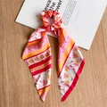 Close-up of vintage floral silk ribbon scrunchie with colorful flower patterns - Red & Orange Satin Ribbon