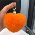 Orange heart-shaped rex rabbit fur keychain with a gold lobster clasp and plush texture - Orange