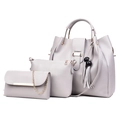 Light gray PU leather 3-in-1 handbag set with gold hardware and tassel charms on white back - Gray