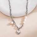 Chunky silver chain necklace with heart pendant and white pearls on a cream background - Silver Heart Pendant Pearl Stitching Necklace
